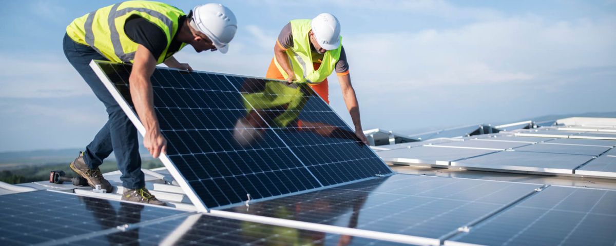 Two workers installing a solar panel