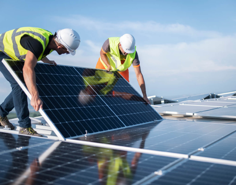 Two workers installing a solar panel